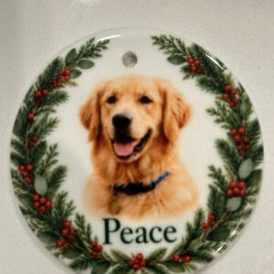 Real sample: personalized ceramic ornament with golden retriever photo, the name 'Peace', and holly wreath border